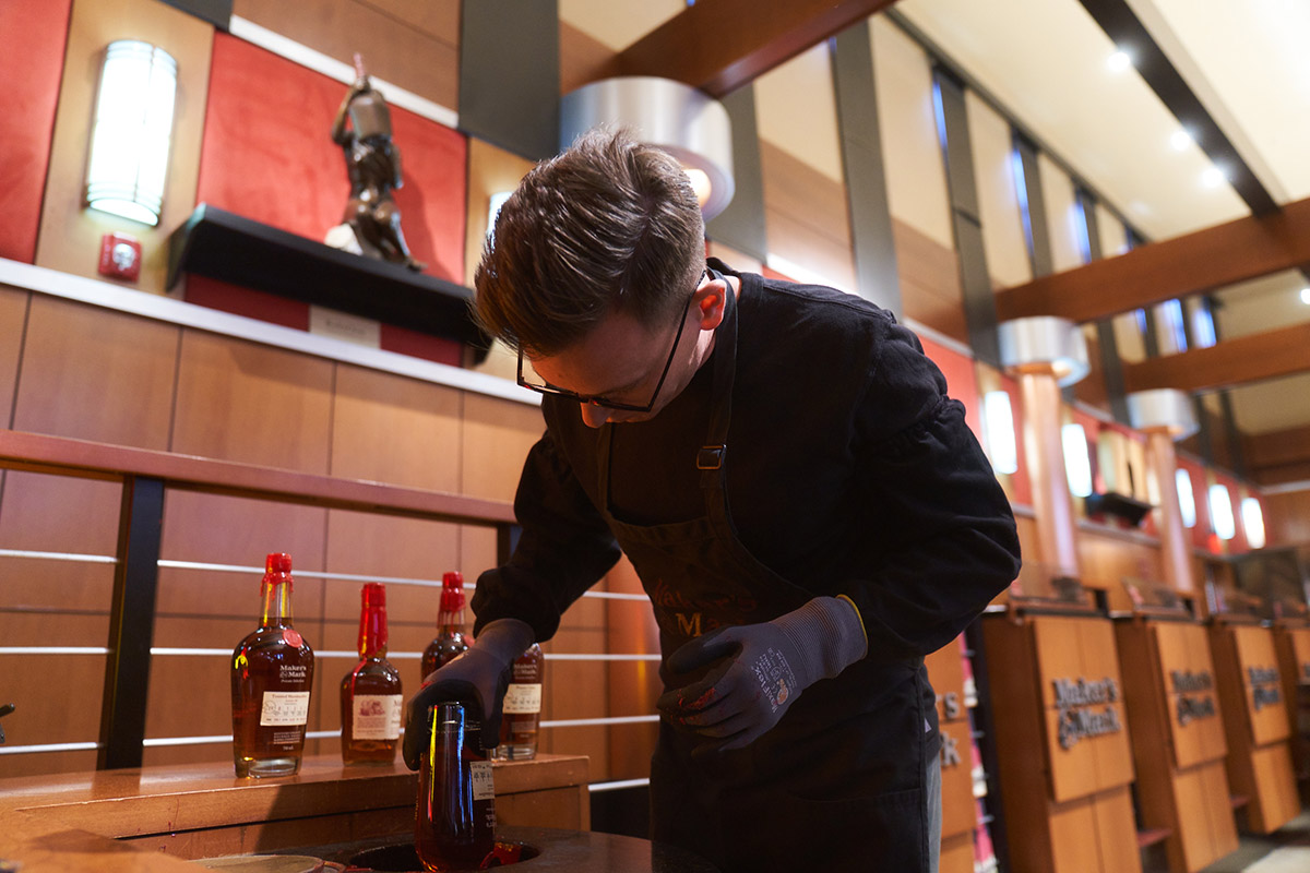 Wax sealing Maker’s Mark bourbon botle