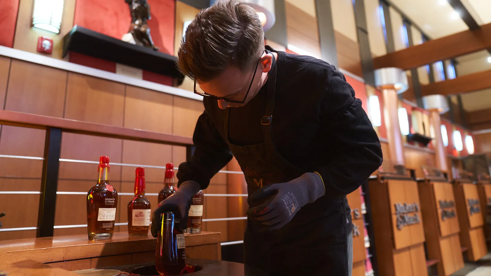 Maker’s Mark sealing bottle with wax at the shop