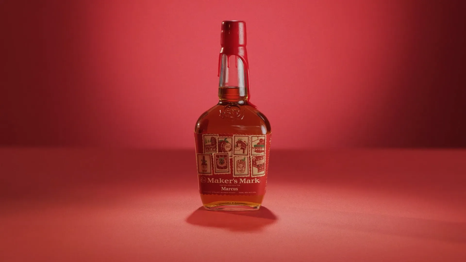A bottle of Maker's Mark bourbon sits on a vibrant red background, featuring its iconic dripping wax seal and festive label design.
